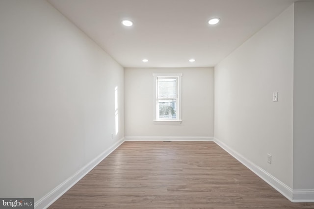 spare room with wood-type flooring