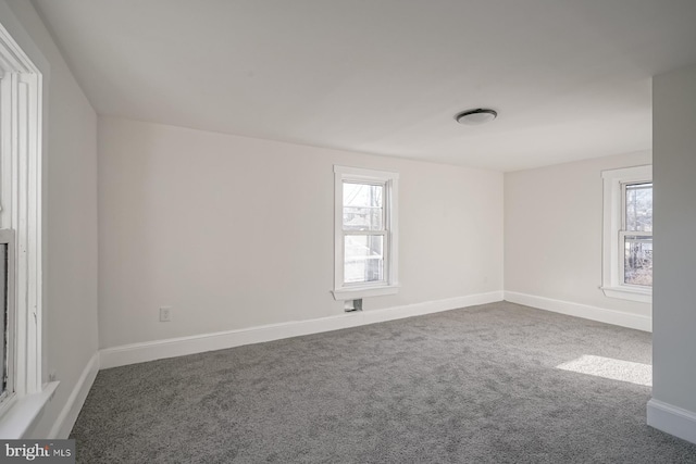 carpeted empty room featuring plenty of natural light