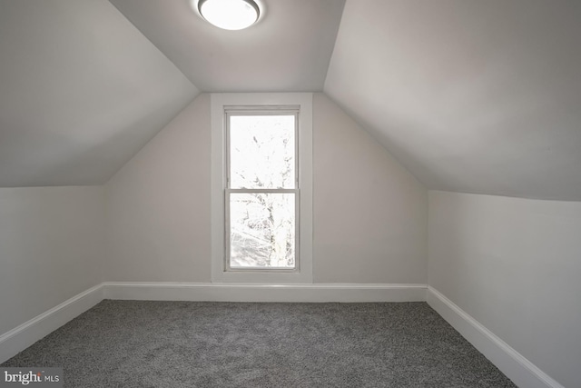 bonus room with carpet floors and vaulted ceiling