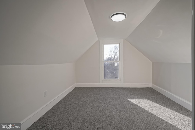 bonus room featuring lofted ceiling and carpet