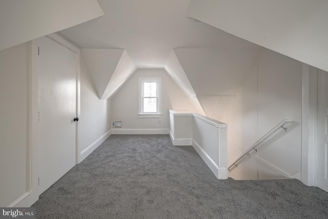 additional living space with carpet flooring and vaulted ceiling