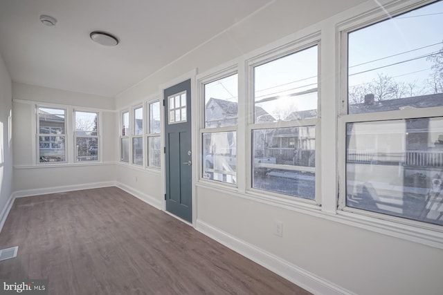 unfurnished sunroom featuring a healthy amount of sunlight