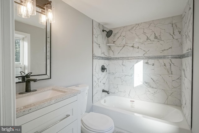 full bathroom with toilet, vanity, and tiled shower / bath