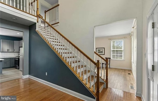 staircase with hardwood / wood-style flooring