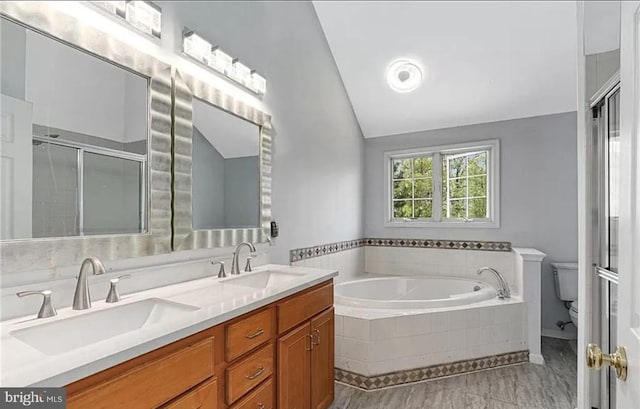 full bathroom with toilet, vaulted ceiling, tile patterned floors, separate shower and tub, and vanity