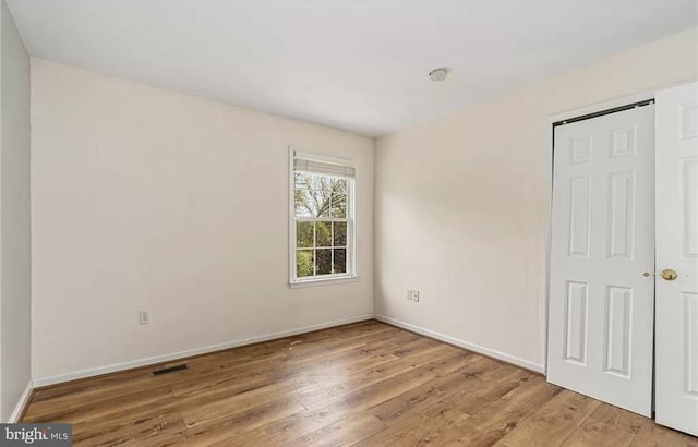 unfurnished bedroom with hardwood / wood-style floors