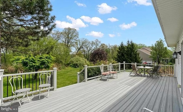 wooden terrace with a yard