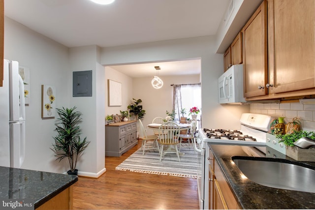 kitchen with white appliances, wood-type flooring, decorative backsplash, decorative light fixtures, and electric panel