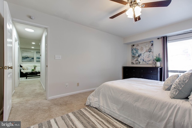 bedroom featuring ceiling fan and light carpet