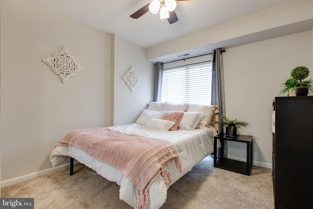 bedroom with ceiling fan and light carpet