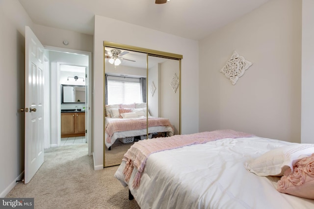 bedroom with light colored carpet, a closet, and ceiling fan