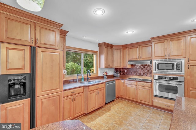 kitchen featuring light stone countertops, built in appliances, sink, backsplash, and light tile patterned floors