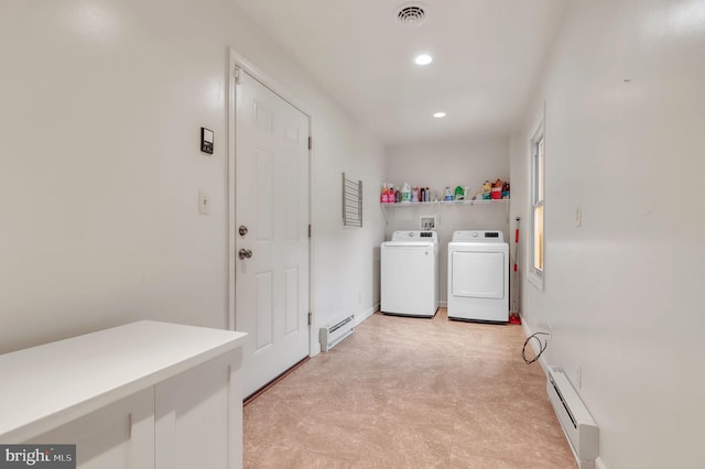 laundry area featuring washing machine and dryer and a baseboard heating unit