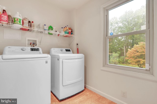 laundry area with light tile patterned floors and separate washer and dryer