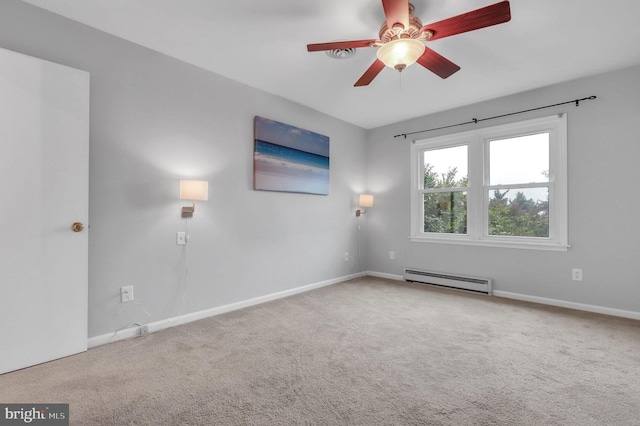 carpeted spare room with ceiling fan and a baseboard radiator