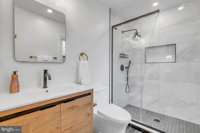 bathroom featuring vanity, toilet, and an enclosed shower