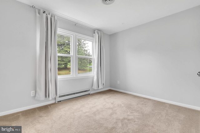 carpeted empty room featuring a baseboard heating unit