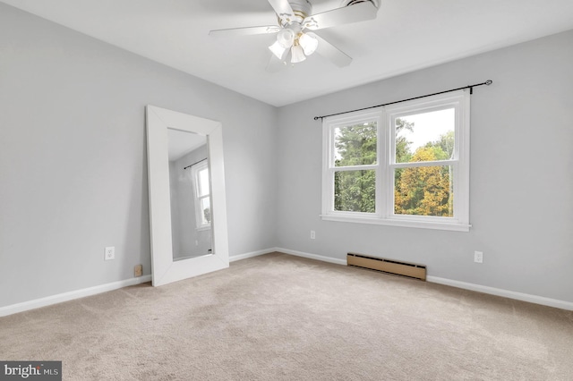 unfurnished room featuring ceiling fan, baseboard heating, and light carpet