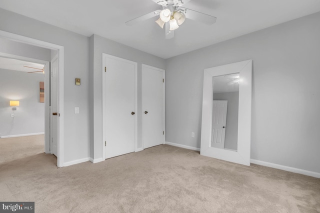 unfurnished bedroom featuring ceiling fan and light carpet