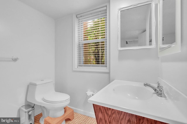 bathroom with vanity, toilet, and tile patterned floors