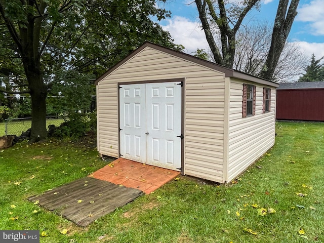 view of outbuilding featuring a lawn