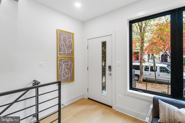 foyer entrance with light hardwood / wood-style floors