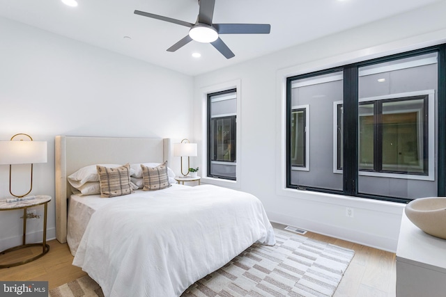 bedroom with ceiling fan and light hardwood / wood-style floors