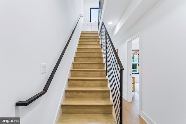 stairs featuring wood-type flooring