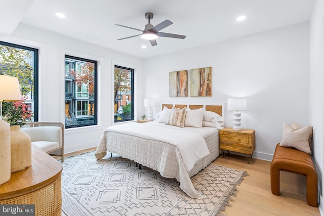 bedroom with ceiling fan and light hardwood / wood-style floors