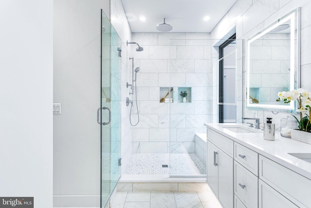 bathroom featuring an enclosed shower and vanity