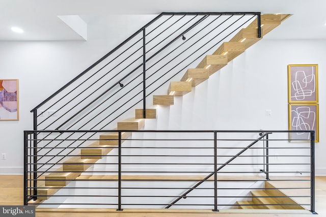 stairway with hardwood / wood-style floors