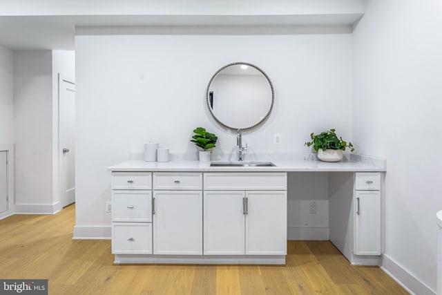 bathroom with hardwood / wood-style floors and vanity