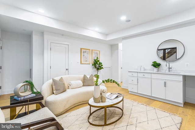 living room with sink and light wood-type flooring