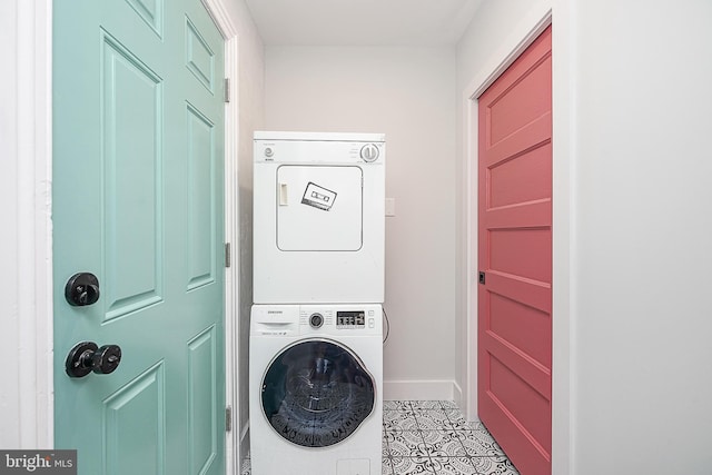 clothes washing area with stacked washer / dryer and light tile patterned floors