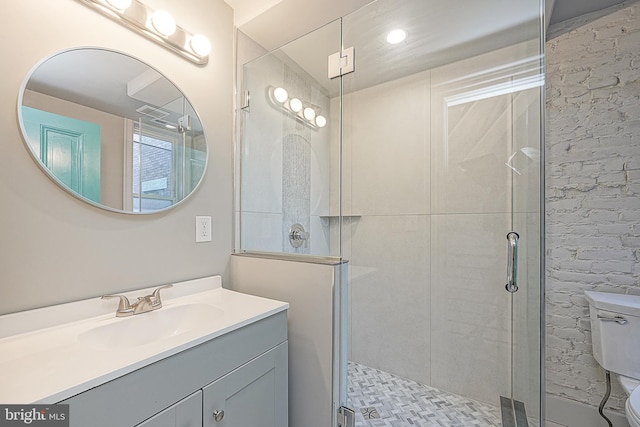 bathroom with toilet, a shower with door, and vanity