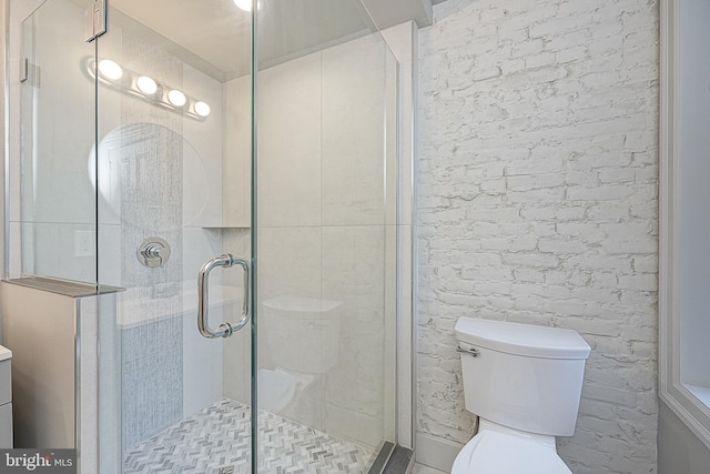 bathroom featuring brick wall, an enclosed shower, vanity, and toilet