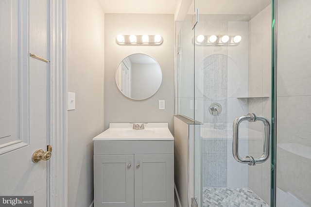 bathroom with walk in shower and vanity