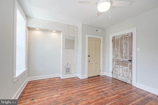 unfurnished bedroom featuring dark wood-type flooring and ceiling fan