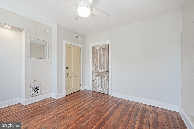 spare room featuring ceiling fan and dark hardwood / wood-style floors