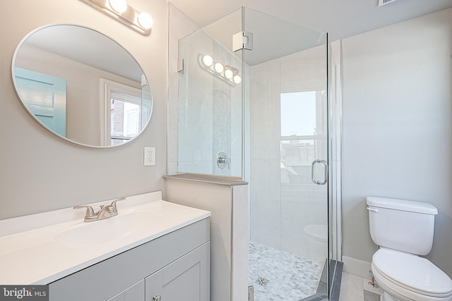 bathroom with toilet, tile patterned flooring, walk in shower, and vanity