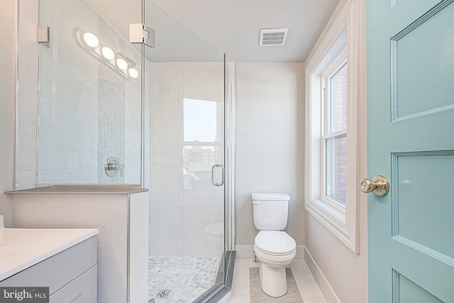 bathroom featuring toilet, tile patterned flooring, walk in shower, and vanity