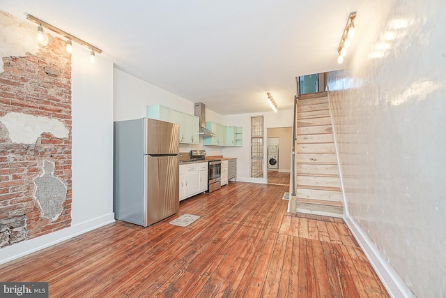 kitchen featuring wall chimney range hood, stainless steel appliances, and light hardwood / wood-style flooring