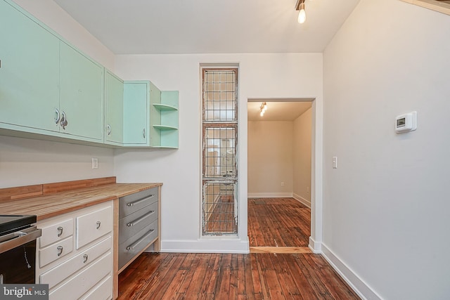 kitchen with stainless steel electric range oven, dark hardwood / wood-style flooring, and wood counters