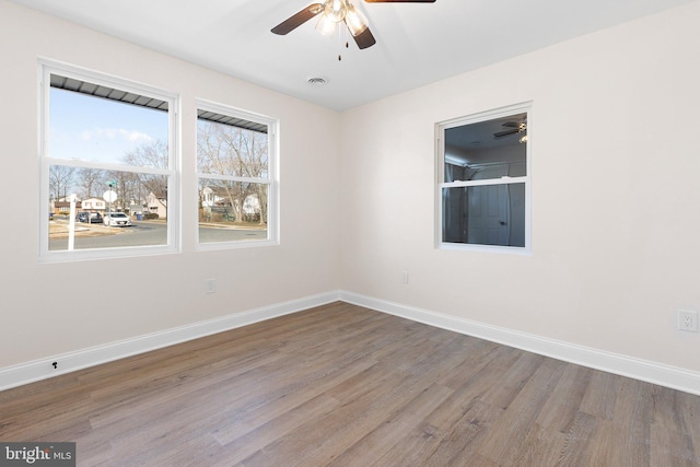 unfurnished room with ceiling fan and hardwood / wood-style flooring