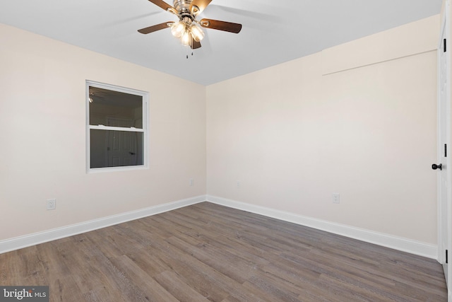 unfurnished room featuring ceiling fan and dark wood-type flooring