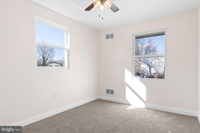 spare room featuring carpet flooring and ceiling fan