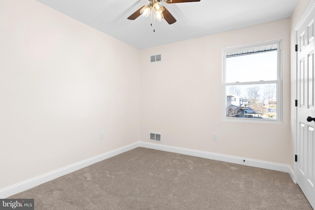 spare room featuring ceiling fan and carpet