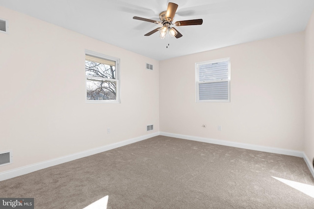 empty room with ceiling fan and carpet