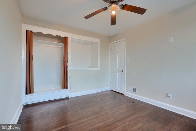 empty room featuring ceiling fan and dark hardwood / wood-style flooring