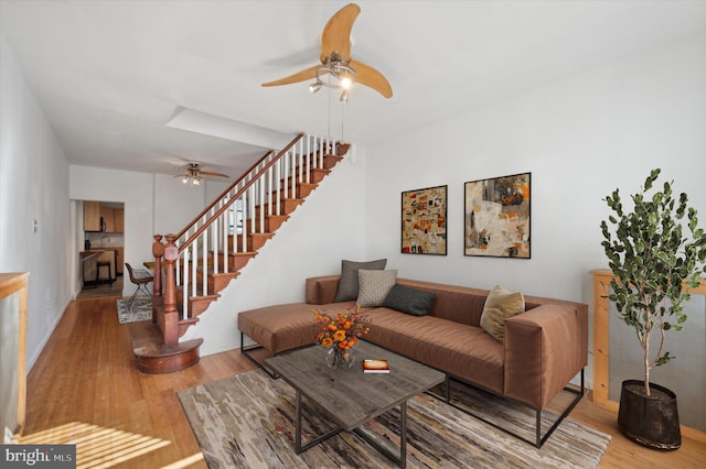 living room featuring ceiling fan and hardwood / wood-style flooring